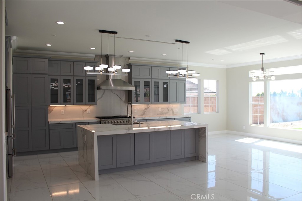 6318 Echo Mountain Rancho Cucamonga, CA 91739 - Photo 8 of 25 a kitchen with kitchen island granite countertop a stove and a sink