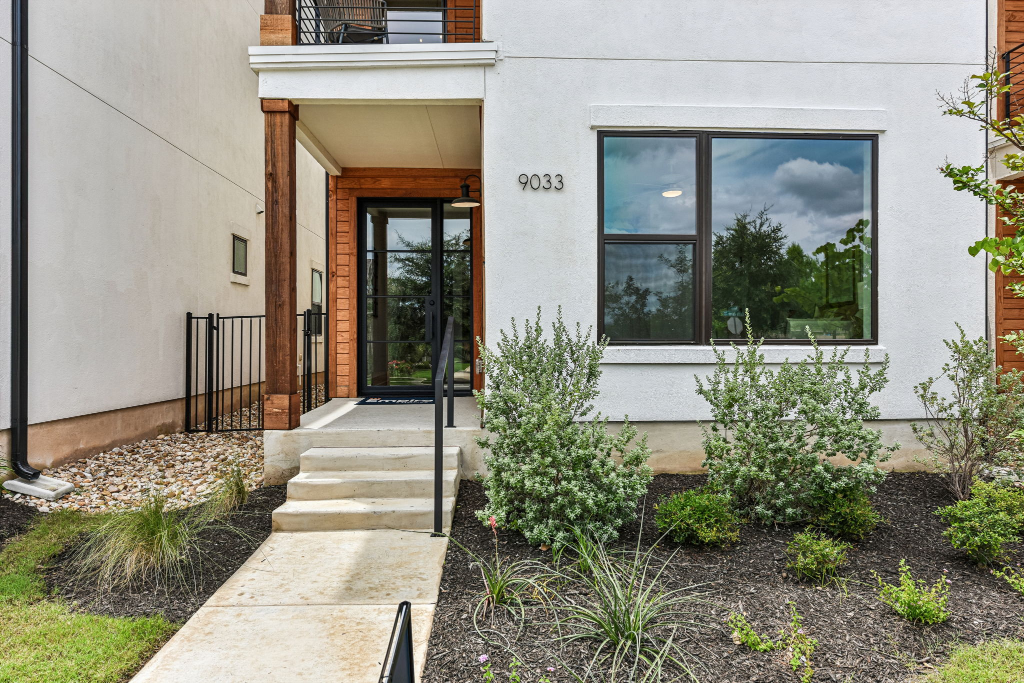 9033 Cattle Baron Path Austin, TX 78747 - Photo 5 of 40 Modern facade with a welcoming entry and thoughtfully designed landscaping.