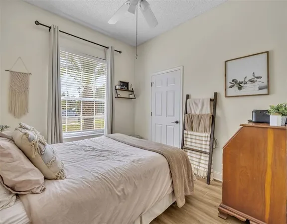 a bedroom with furniture and a window