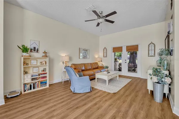 a living room with furniture and a book shelf