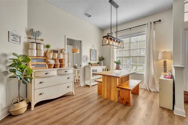a room with furniture a chandelier and wooden floor
