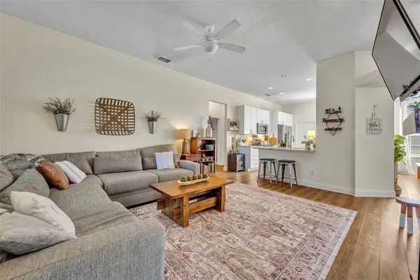 a living room with furniture and wooden floor