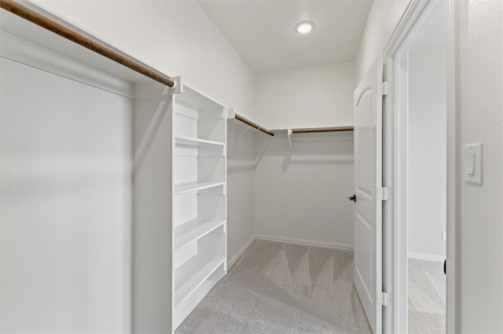 137 Moss Gln Lane Rhome, TX 76078 - Photo 15 of 25 a view of walk in closet with empty racks