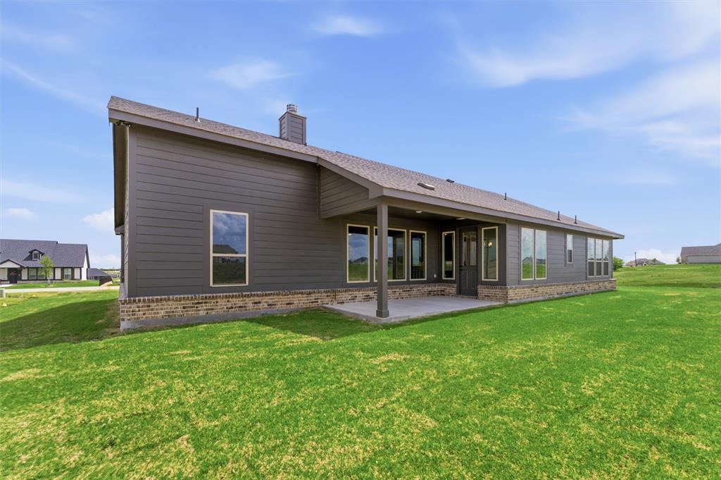 137 Moss Gln Lane Rhome, TX 76078 - Photo 22 of 25 a view of a house with a yard and sitting area