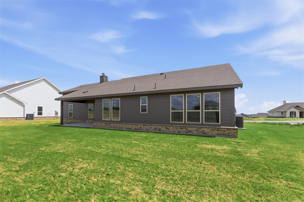 137 Moss Gln Lane Rhome, TX 76078 - Photo 24 of 25 a house view with a garden space