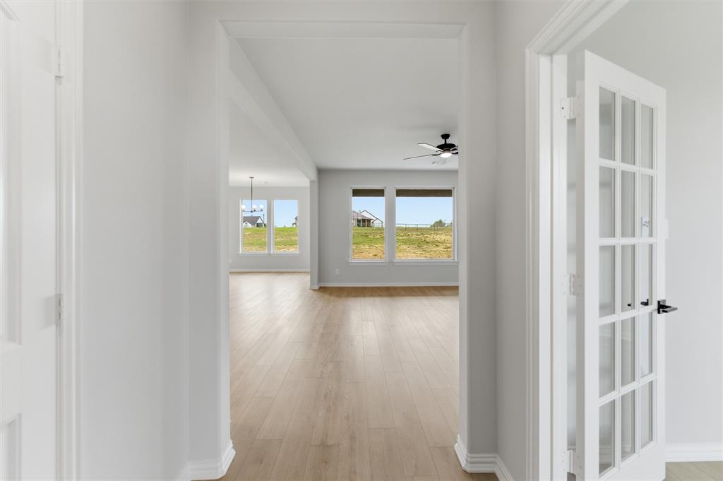 137 Moss Gln Lane Rhome, TX 76078 - Photo 5 of 25 a view of an entryway with wooden floor and a window