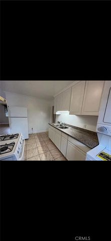 a view of a kitchen with wooden floor