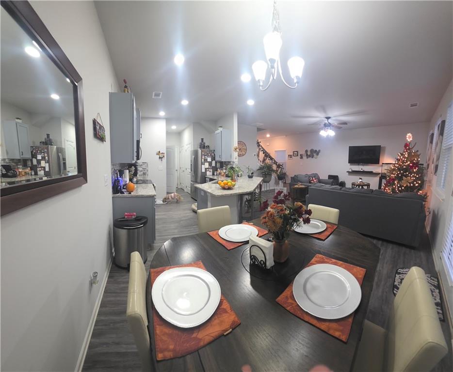 4768 Rdg Vly Drive Gainesville, GA 30504 - Photo 12 of 23 a dining room with lots of white furniture a chandelier and a wooden floor