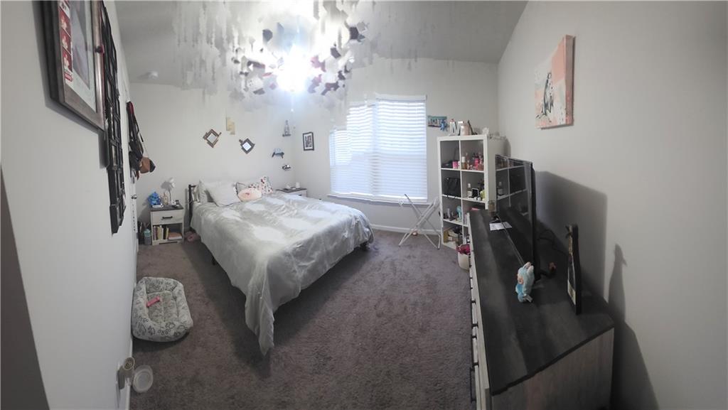 4768 Rdg Vly Drive Gainesville, GA 30504 - Photo 3 of 23 a bed room with a bed and a chandelier