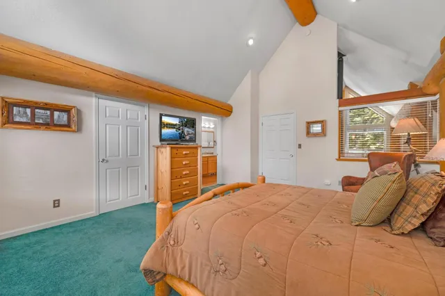 a living room with furniture and a kitchen