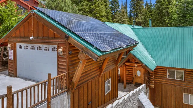 a view of a wooden house with a yard