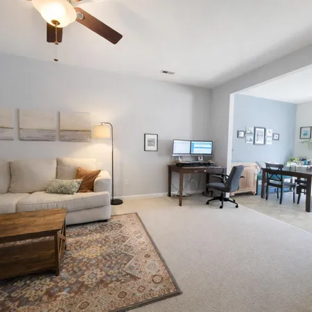 a living room with furniture and a rug