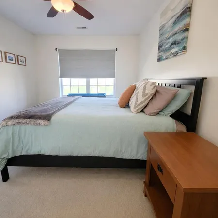 a living room with a bed furniture and a window