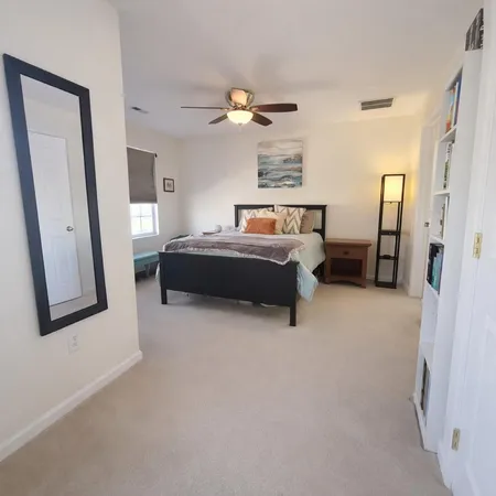 a room with a bed and mirror