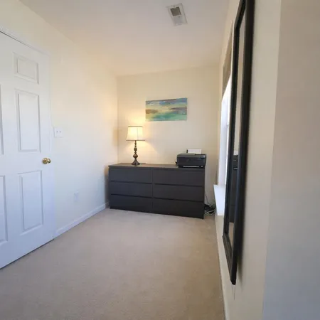 a close view of walk in closet with clothes