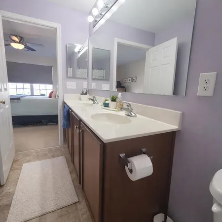 a bathroom with a sink a mirror and a shower
