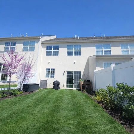 a view of a house with a backyard