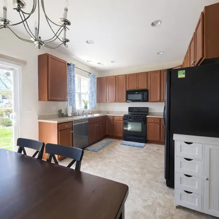 a kitchen with granite countertop a stove a sink and a microwave
