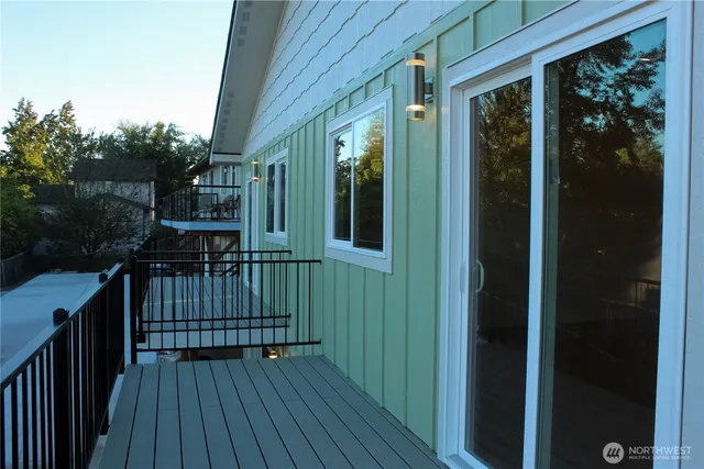 a view of balcony with wooden floor and fence
