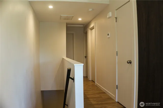 a view of hallway with wooden floor