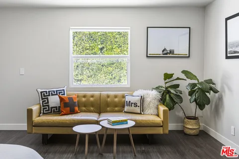 a living room with furniture and a potted plant