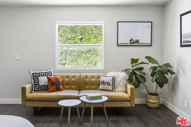 a living room with furniture and a potted plant
