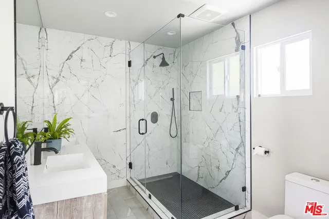 a bathroom with a shower and a sink