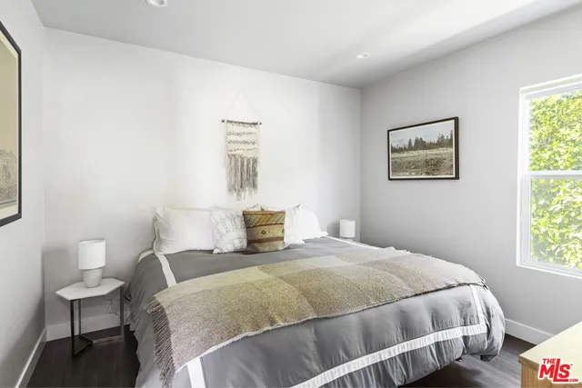 a bedroom with a bed and chair