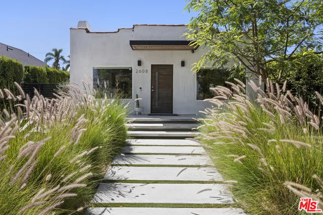 a view of a house with potted plants