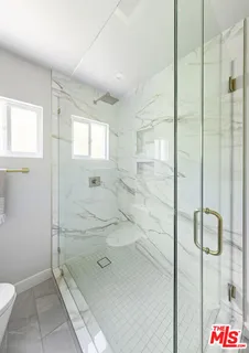a bathroom with a shower and toilet