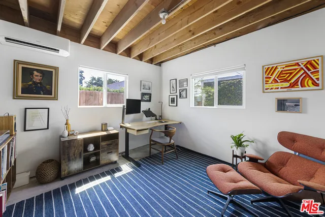 a living room with furniture a rug and wooden floor