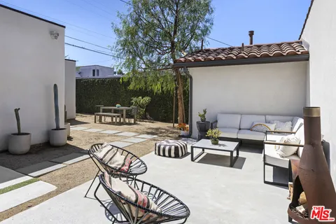 a view of a patio with table and chairs and potted plants