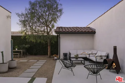 a view of a chairs and table in patio