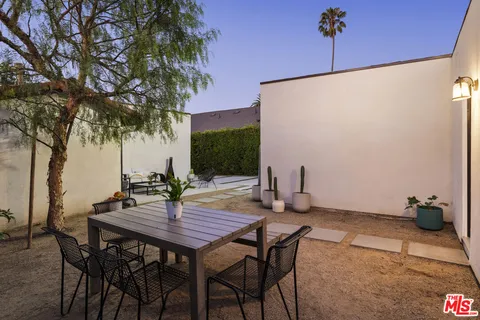 a view of an outdoor space with a table and chairs