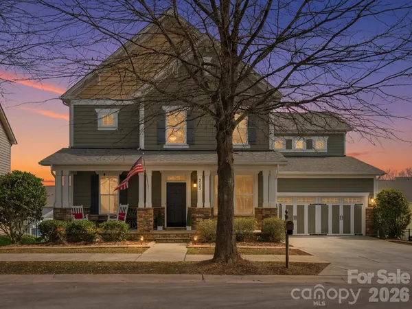 front view of a brick house with a small yard