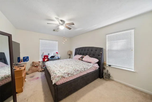 a bed room with a bed mirror and a window