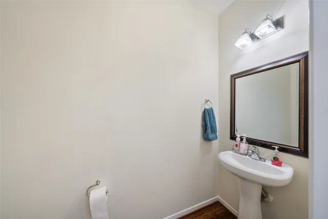 a bathroom with a sink and mirror with toilet