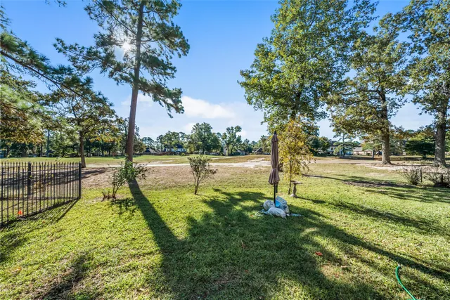 a view of a yard with swimming pool