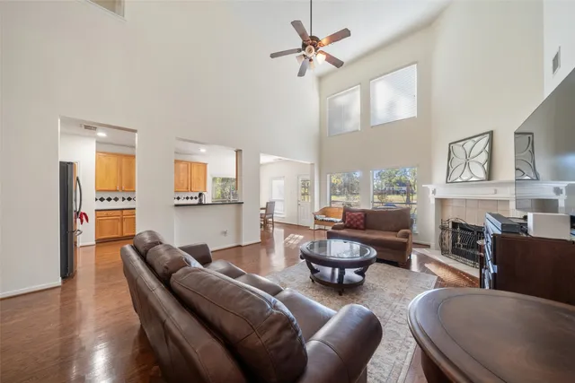 a living room with fireplace furniture and a wooden floor