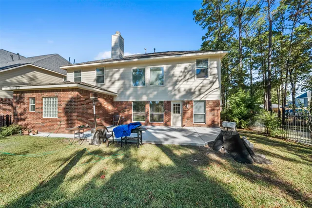 a view of a house with a yard patio and fire pit