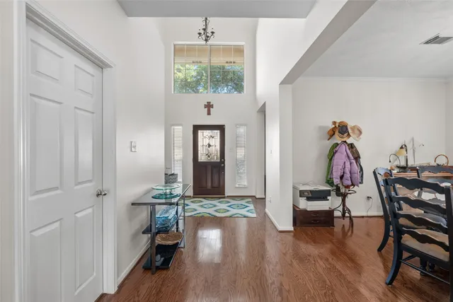 a view of a hallway with wooden floor and furniture