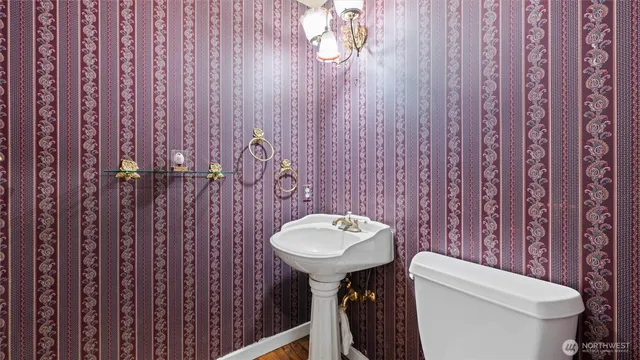 a bathroom with a sink toilet and a mirror