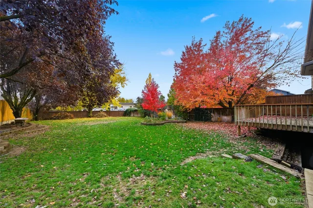 a view of a garden with a house in the background
