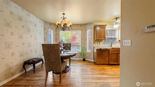a view of a dining room with furniture and chandelier