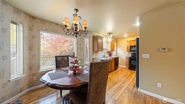 a view of a dining room with furniture wooden floor and chandelier