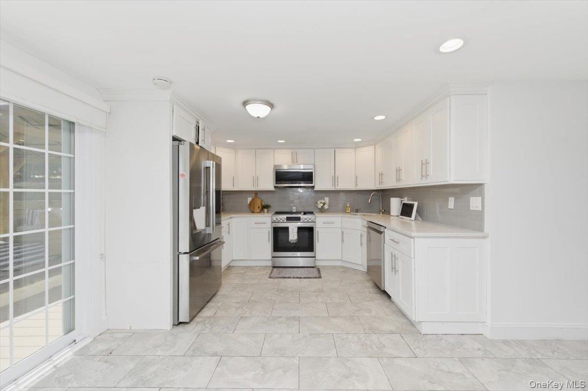 10 Rutgers Road Farmingville, NY 11738 - Photo 10 of 27 a large kitchen with cabinets and stainless steel appliances