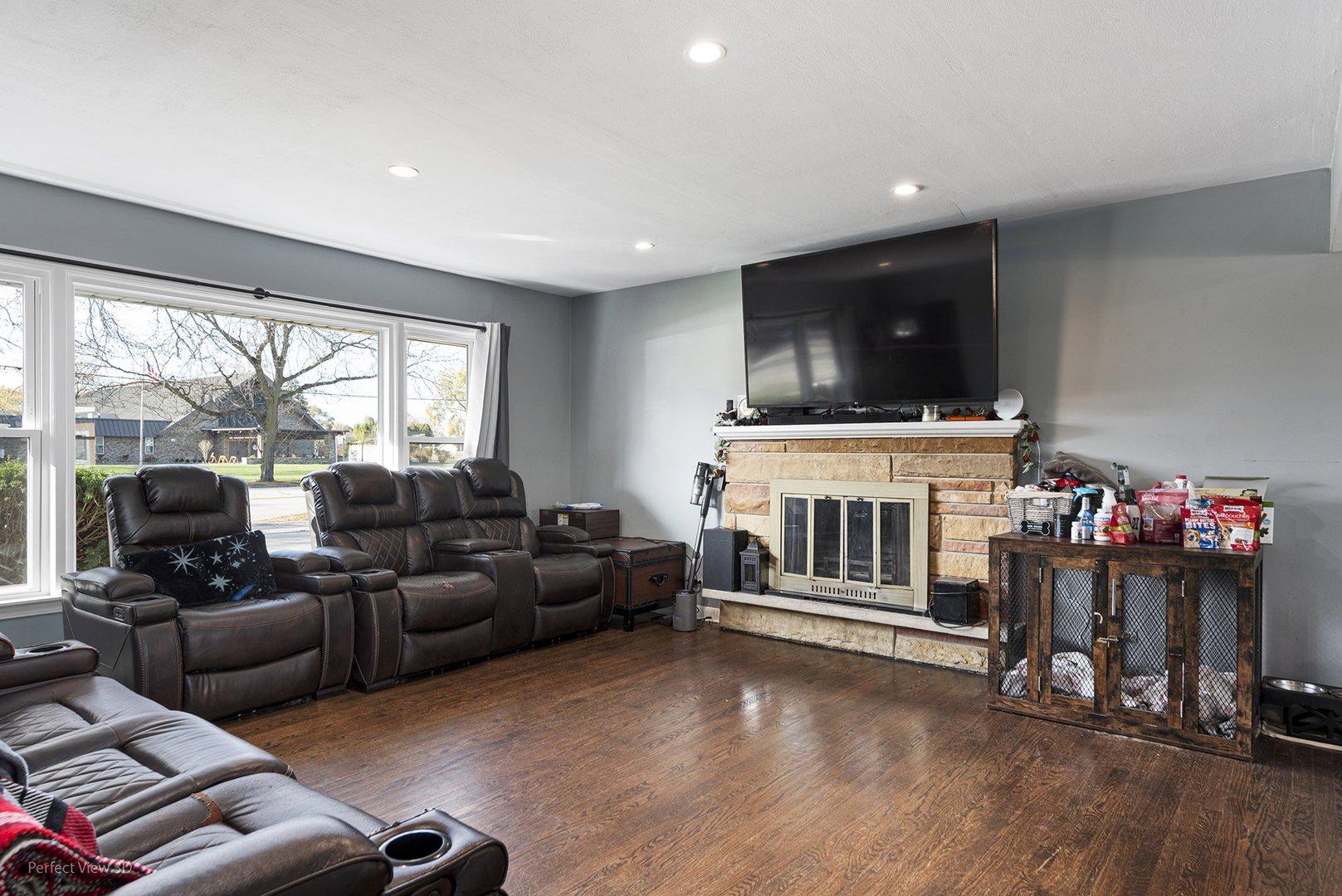 9007 Ridgeland Avenue Oak Lawn, IL 60453 - Photo 2 of 22 a living room with furniture a flat screen tv and a floor to ceiling window