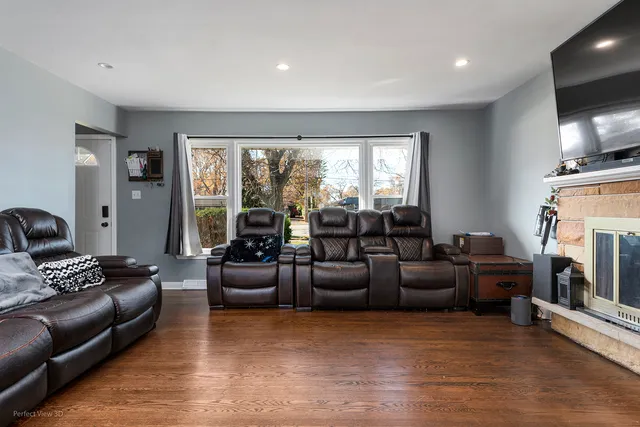 a living room with fireplace furniture and a flat screen tv