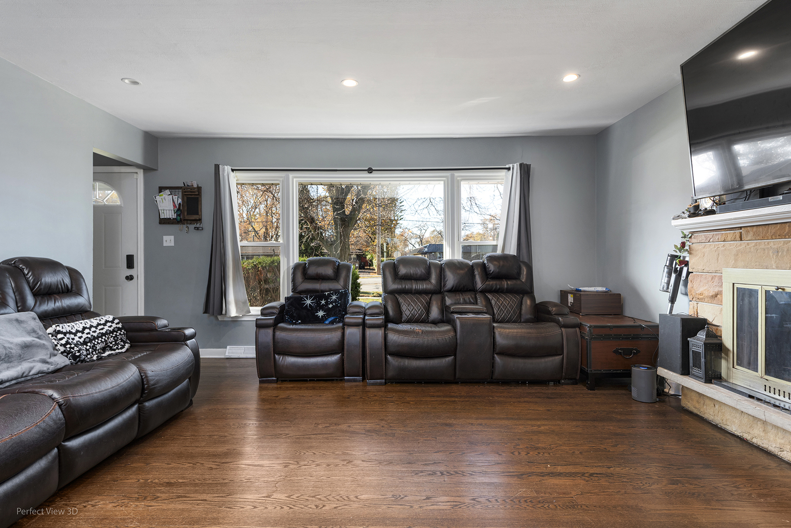 9007 Ridgeland Avenue Oak Lawn, IL 60453 - Photo 4 of 22 a living room with fireplace furniture and a flat screen tv