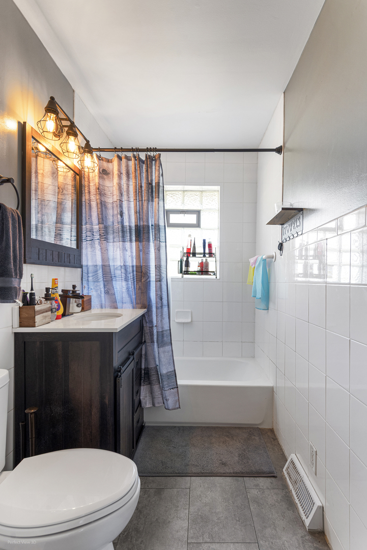 9007 Ridgeland Avenue Oak Lawn, IL 60453 - Photo 10 of 22 a bathroom with a toilet a sink and bathtub